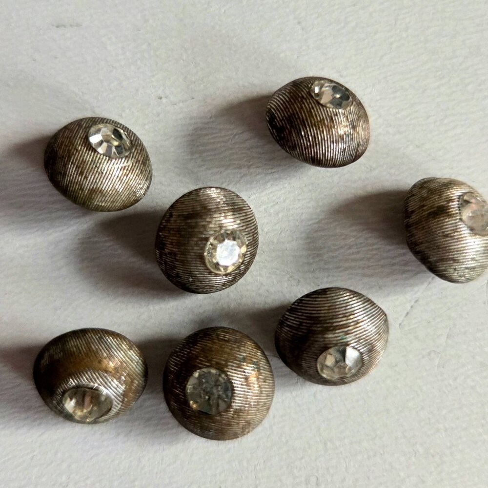 7 small vintage metal buttons with clear rhinestone.